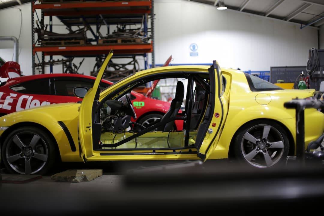 yellow-mazda-rx8-having-a-roll-cage-installed